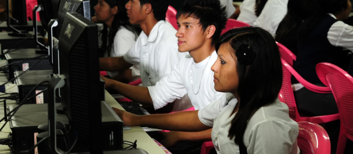 Teenage students using computers in a classroom