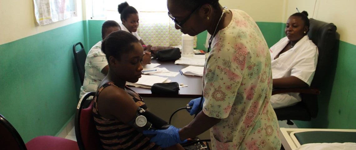 A nurse checking a woman in a health center in Haiti. Photo: World Bank