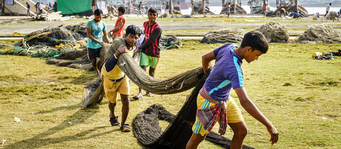 Fishermen working with the nets at a park in Chittagong, Bangladesh. Photo: Alexey Stiop / Shutterstock.com