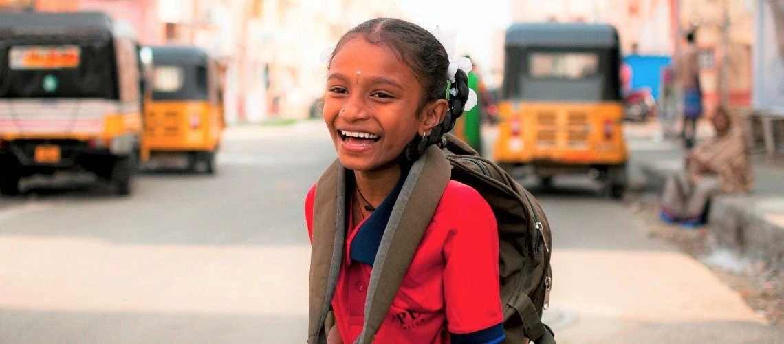 School girl crossing the street in her way to school