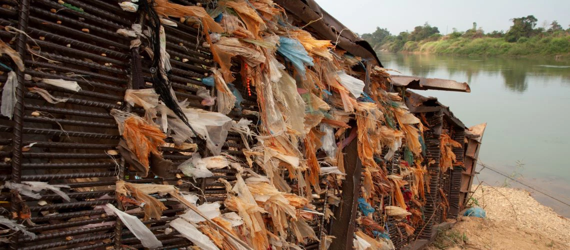 Plastic trapped in an abandoned structure on the Mekong River, Laos