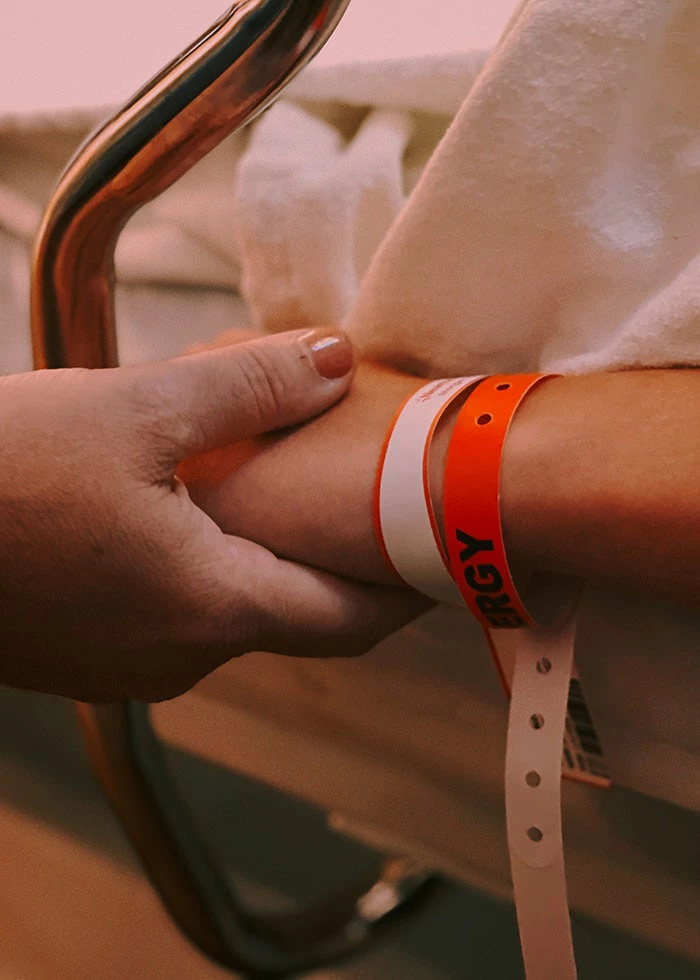 A person holding hand in a hospital. | © Jon Tyson / Unsplash