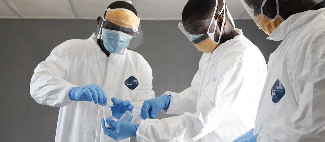 Doctors work together closely to take a sample swab at C.H. Rennie Hospital in Kakata, Margibi County in Liberia on March 10, 2016. 