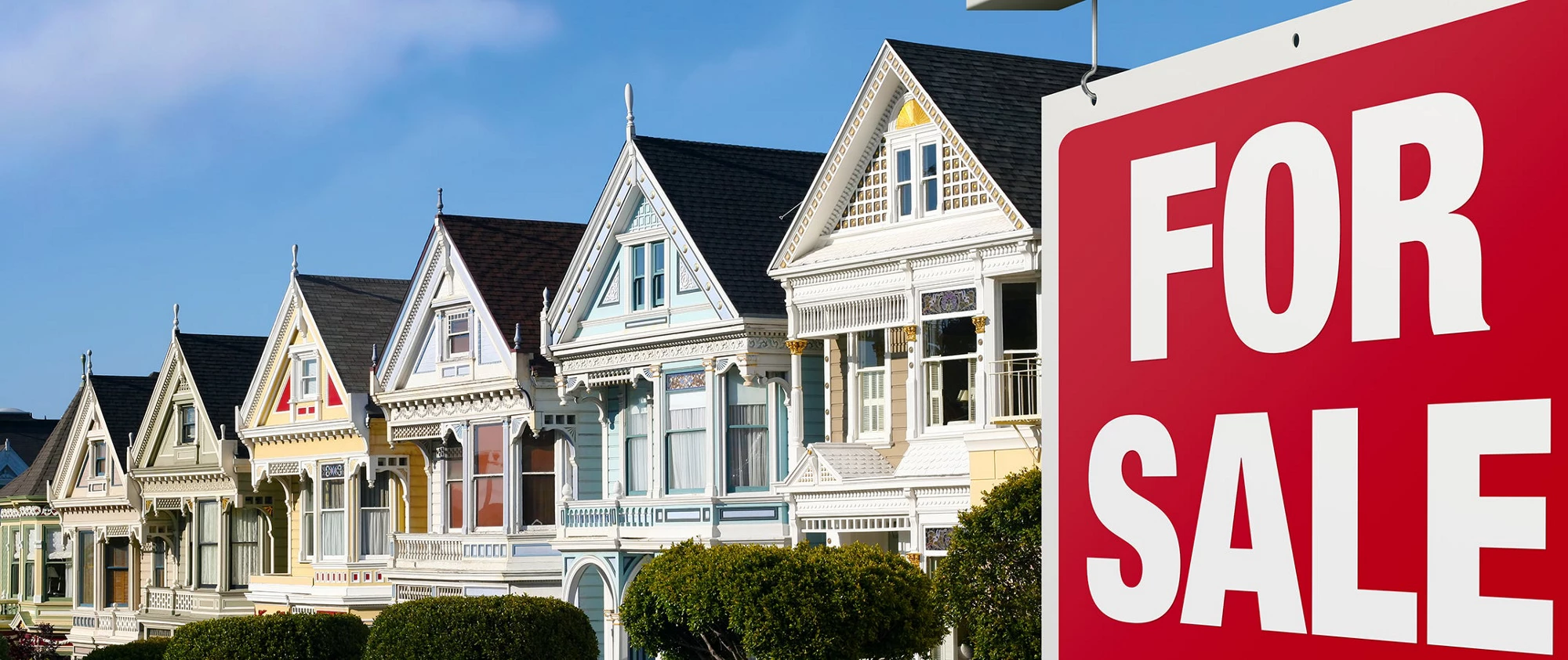 Row of houses and a "For Sale" sign is visible in front.