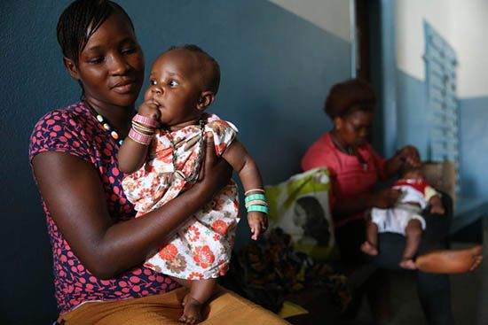 Mary Thullah 20-year old mom comforts her daughter Fatmata Turay after she received vaccinations at the Princess Christian Maternity Hospital on March 10, 2015 in Freetown Sierra Leone. Photo © Dominic Chavez/World Bank