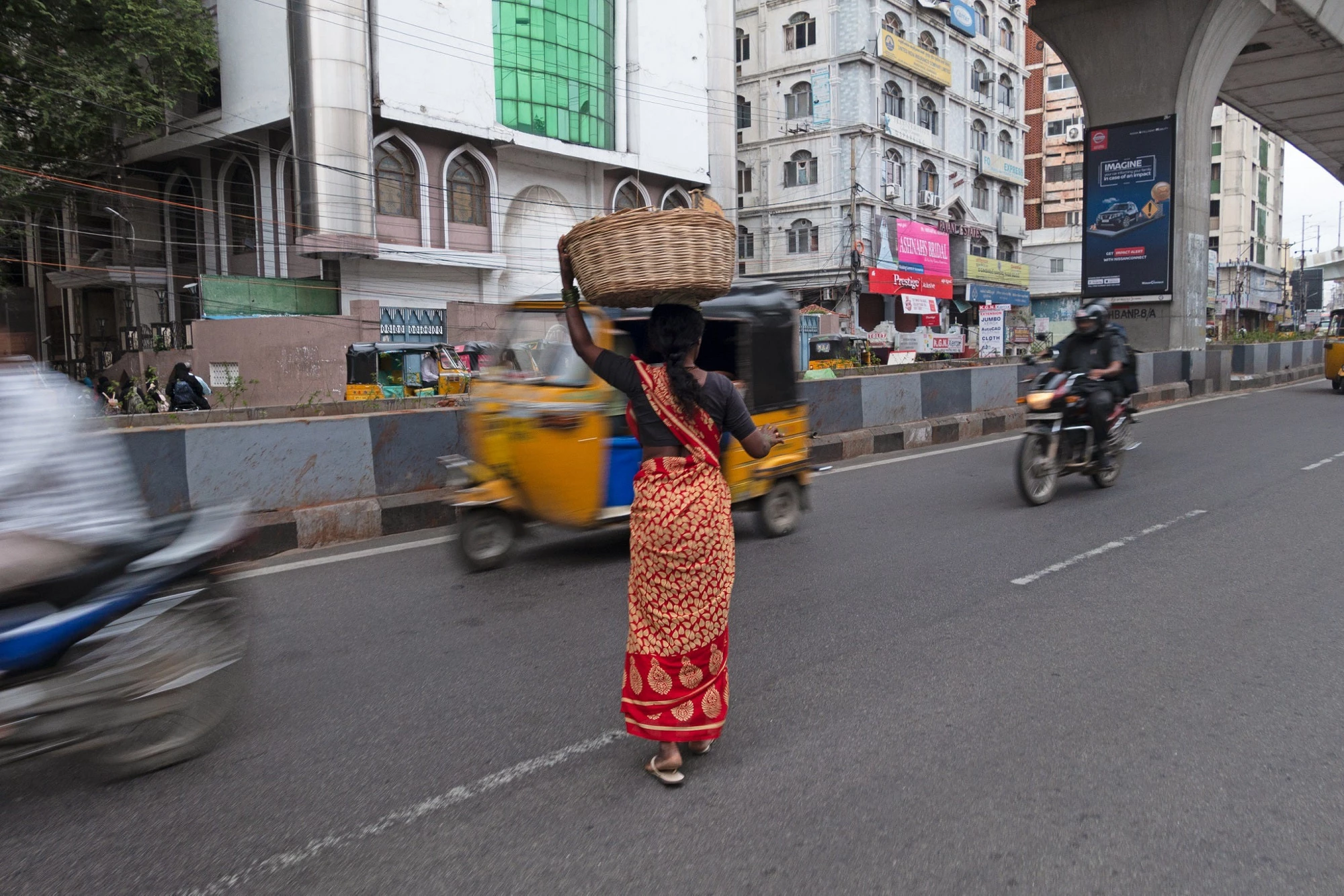 Woman crossing the street in Hyderabad, India.