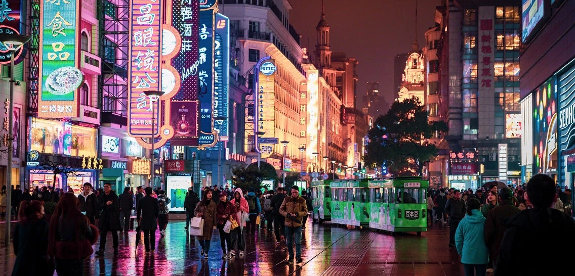 People walking in a theater district in Shanghai (photo from Unsplash)