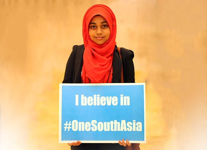 Young Indian Female Student holding a 