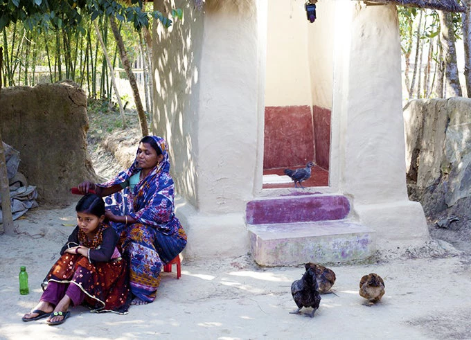 A toilet in Chunarughat, Hobigonj reduces fecal contamination for this family (World Bank/M. Monir)