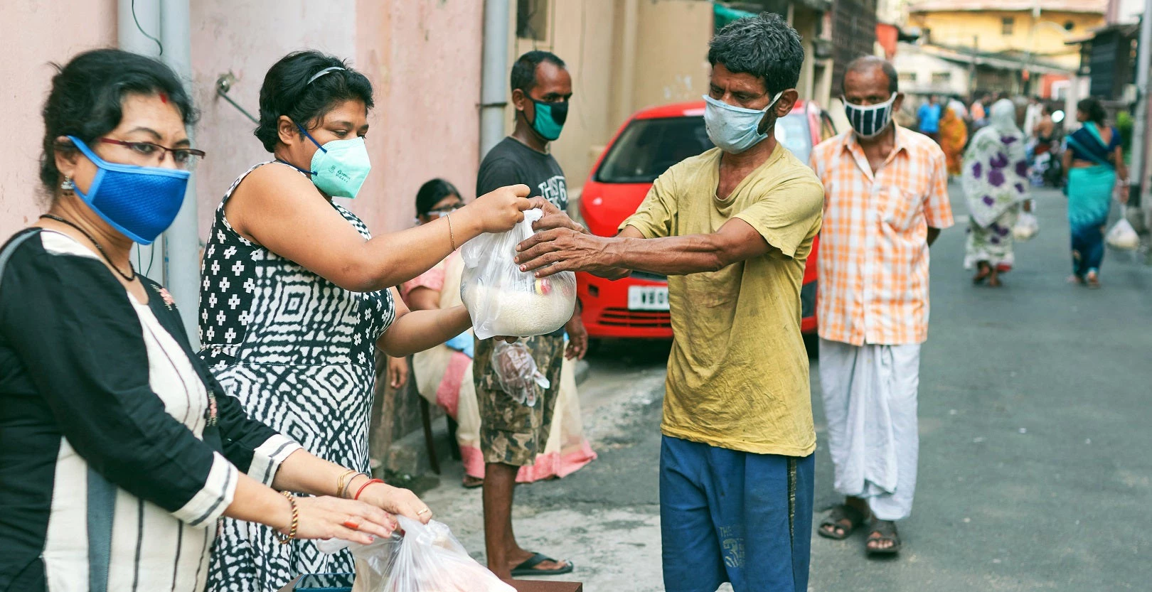 Volunteers distribute grocery items to people in need in Kolkata, India. Photo: © suprabhat/Shutterstock