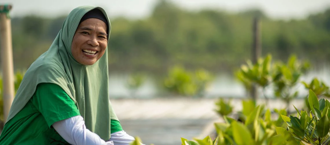 Nini working at a mangrove rehabilitation site in Indonesia.