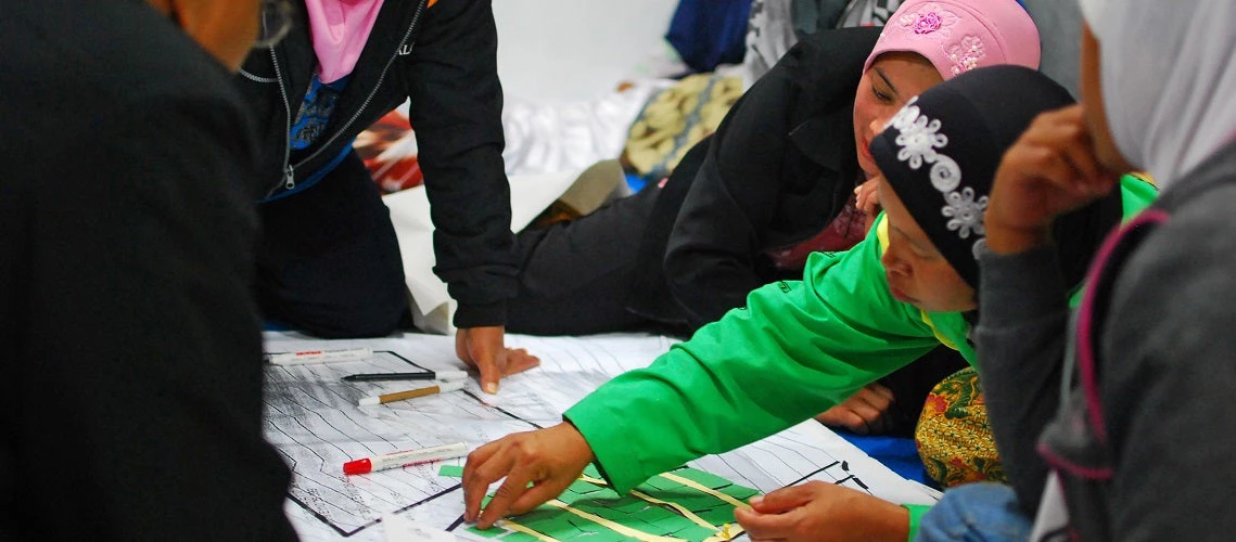 Women at a community meeting discussing the reconstruction of the village hit by volcanic eruption. Yogyakarta, Indonesia.