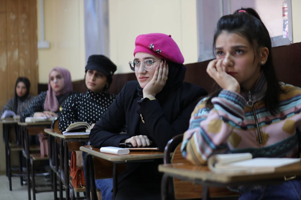 Young women students sit in class in Iraq.
