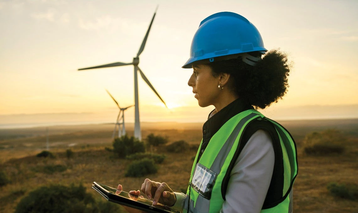 Worker in front of a wind turbine