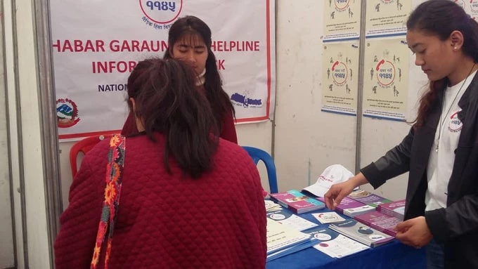 Visitors gather to receive information about the helpline