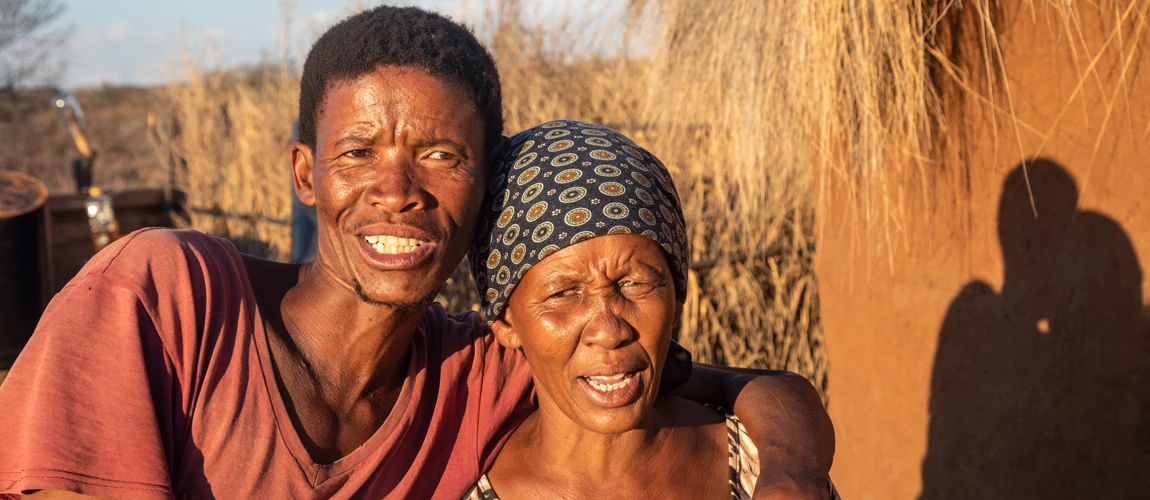 African couple in front of the house