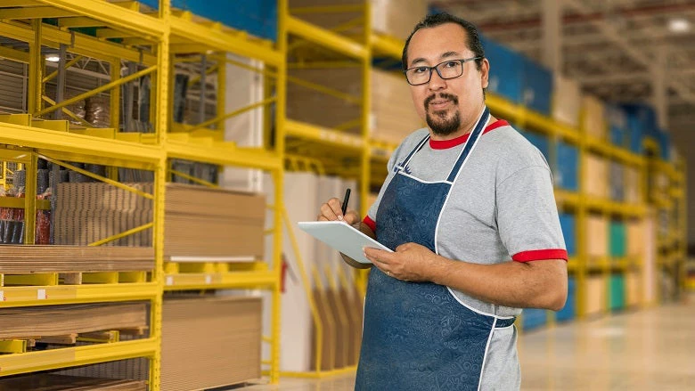 male employee worker or entrepreneur happily doing his daily chores in the store where he works