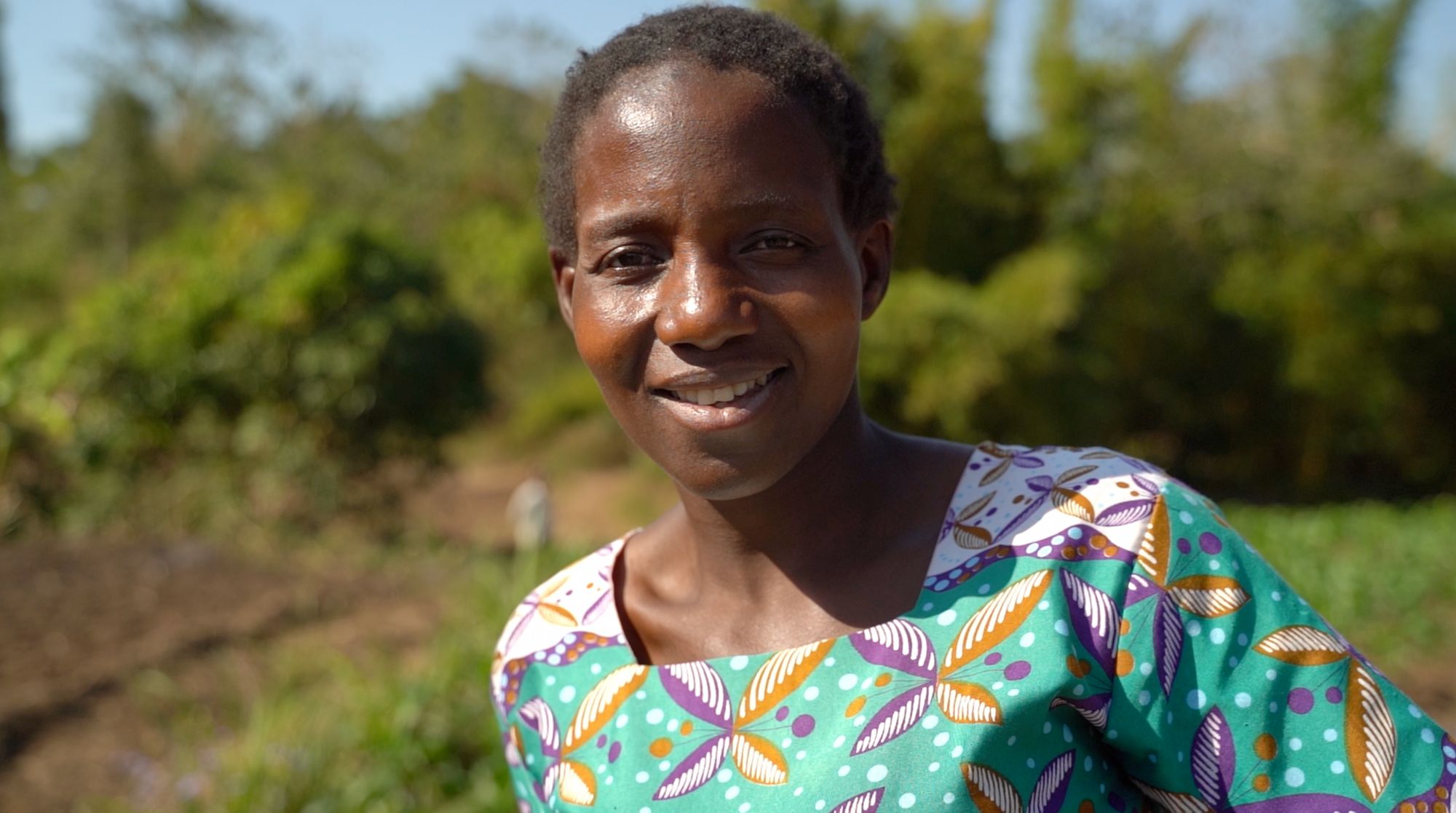 A smiling Jeya Nsinda, farmer and mother from Thoylo District, Malawi. Photo: IFC