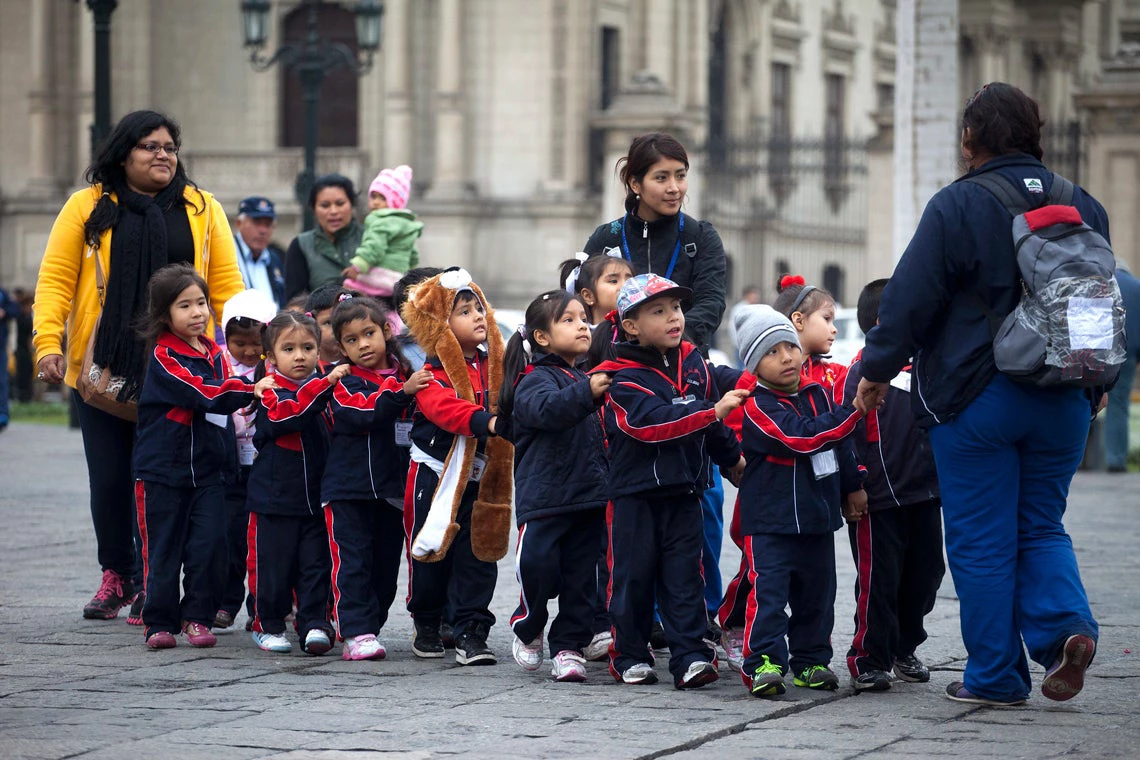 Kindergarten students from Bertolt Brecht School walk through the Plaza de Armas in Lima, Peru on June 28, 2013