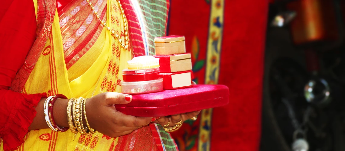 An Indian Bengali bride woman holding dowry for her husband