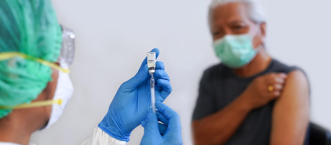 Nurse vaccinates an elderly patient