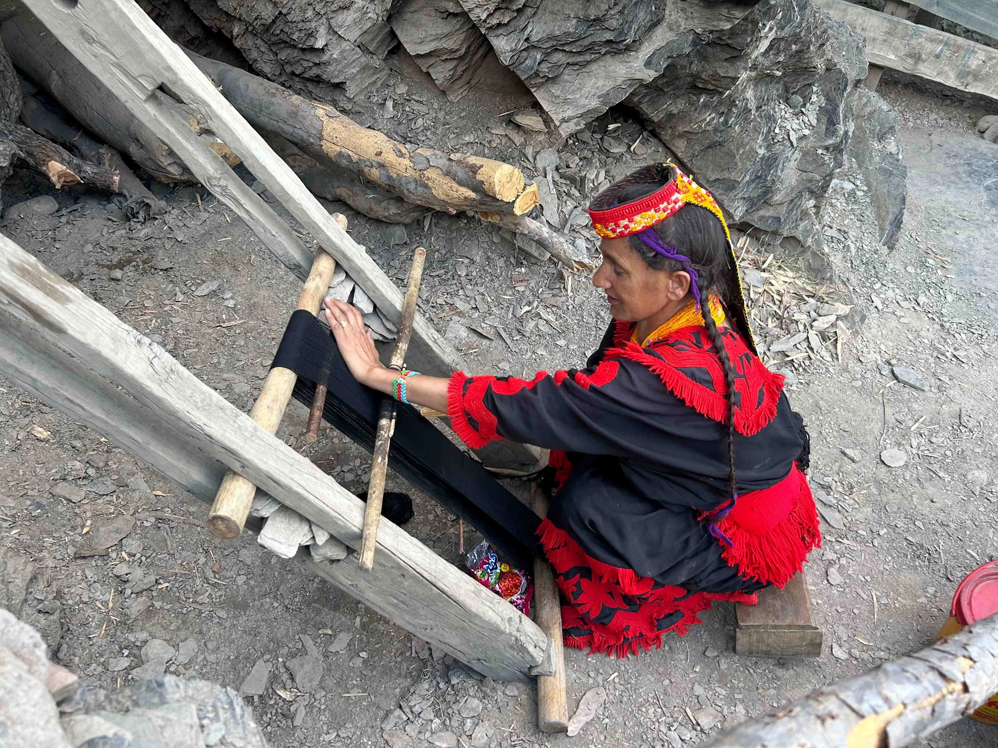 A Kalash woman demonstrating their traditional weaving practice