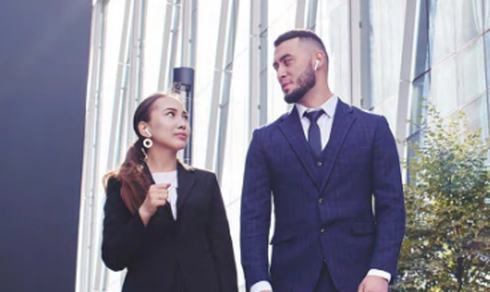 Businesswoman and businessman walking side-by-side in Kazakhstan