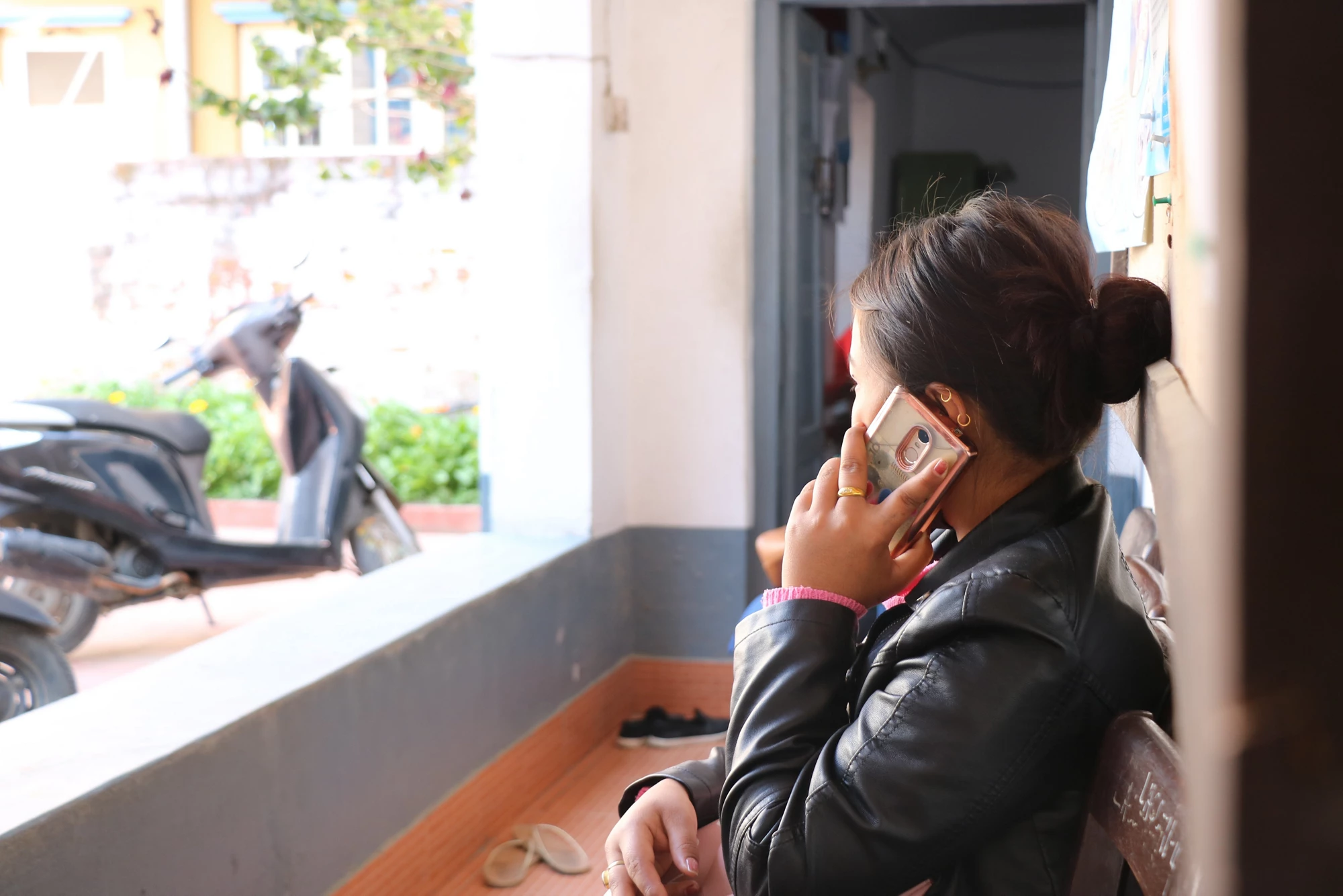 A women speaking on her mobile phone facing away from the camera