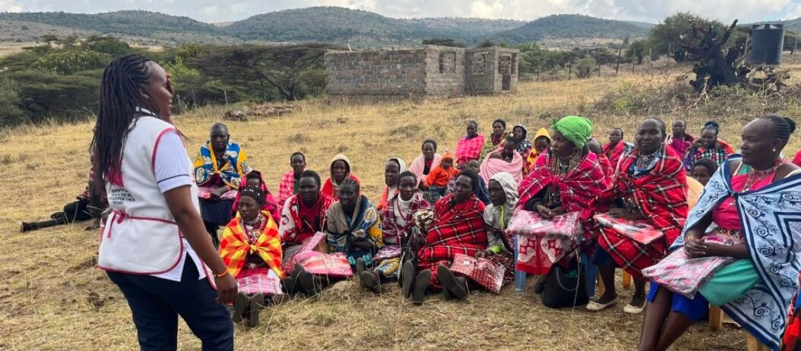 Reginah, a nurse trained under Kenya?s program, discusses health practices with women and adolescents in her community