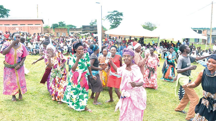 In Golomolo, Uganda, women celebrate victory after Buganda Land Board helped them have a fraudulent land title canceled. 