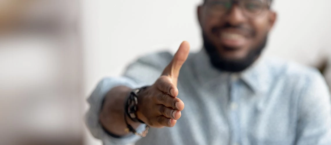 African American professional extending hand for handshake | © shutterstock.com