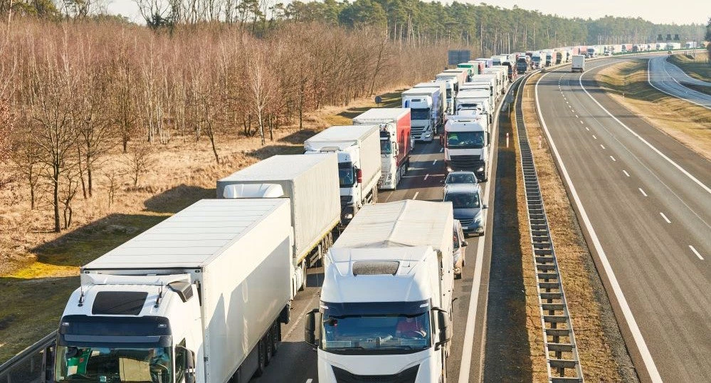 Lorry truck stack in long traffic jam on lane.