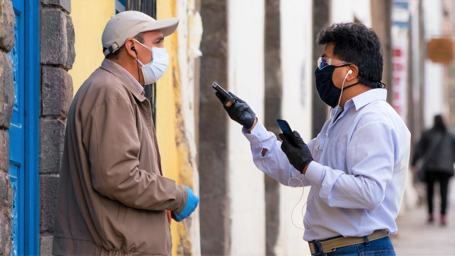 Man conducting an interview about the covid-19 pandemic in Cusco, Peru.