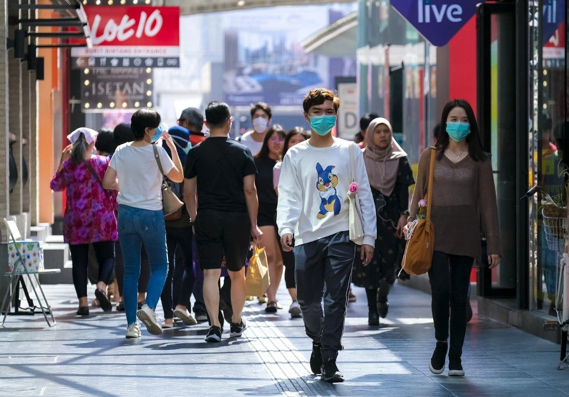 Malaysians in the Kuala Lumpur city center prior to the announcement of the Movement Control Order (MCO) in an effort to control the spread of the COVID-19. The country now faces new challenges as a result of the global economic environment and the public health crisis brought on by the pandemic. 