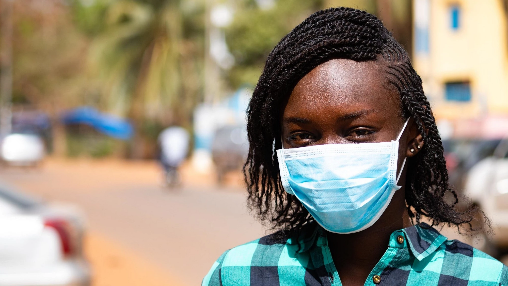 Woman in Mali wears a protective mask covering her nose and mouth