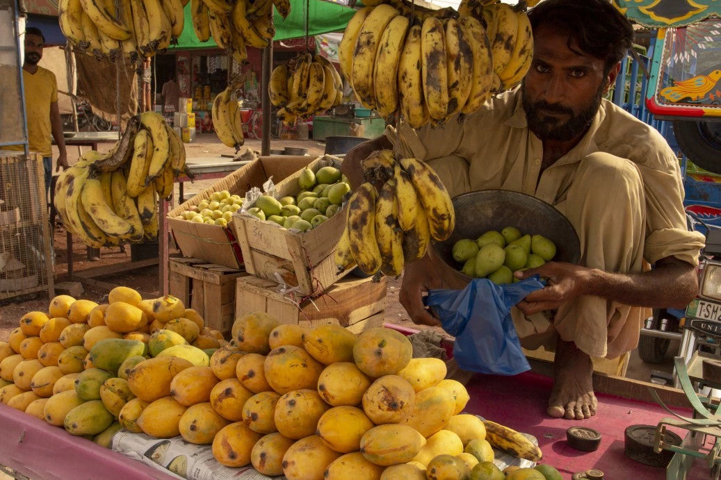 Mango seller at his stall in the market