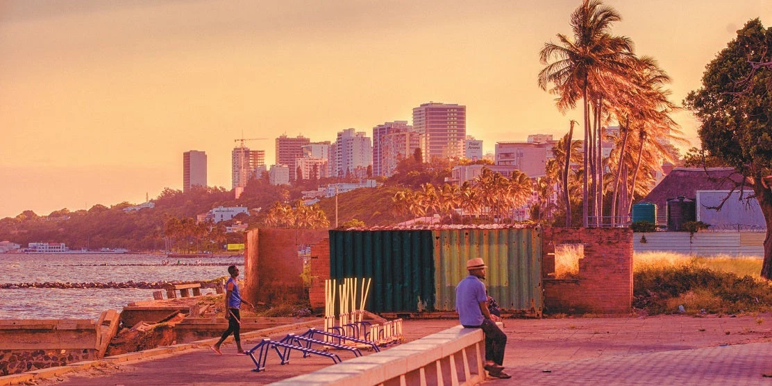 Sea, city skyline, Maputo, Mozambique, man sitting