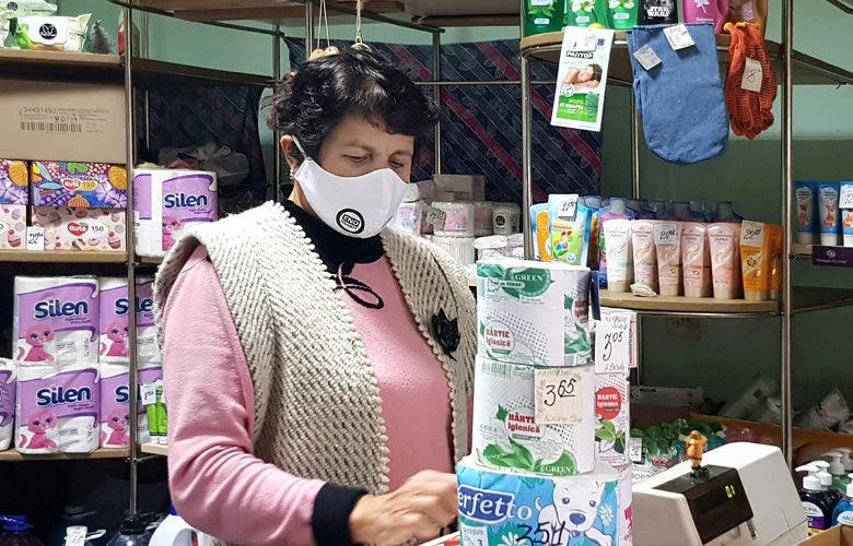 Moldovan lady in a shop wearing a mask