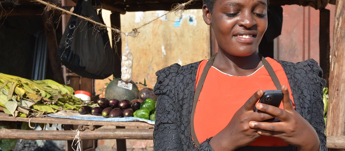 Airtel Money introduces mobile banking services to business owners such as Sarah (depicted) | Photo by: Anna Koblanck/IFC