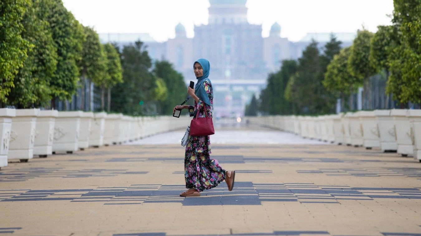 A Malaysian civil servant walks in front of the Prime Minister?s Office in the administrative capital of Putrajaya.