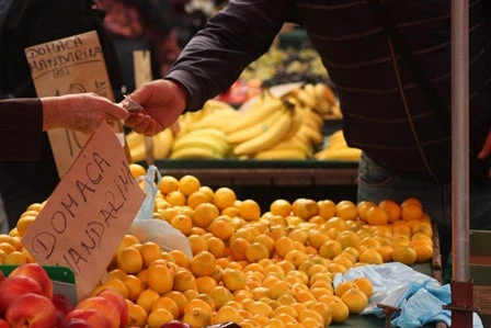 Money trade hands at a market in Zagreb, Croatia