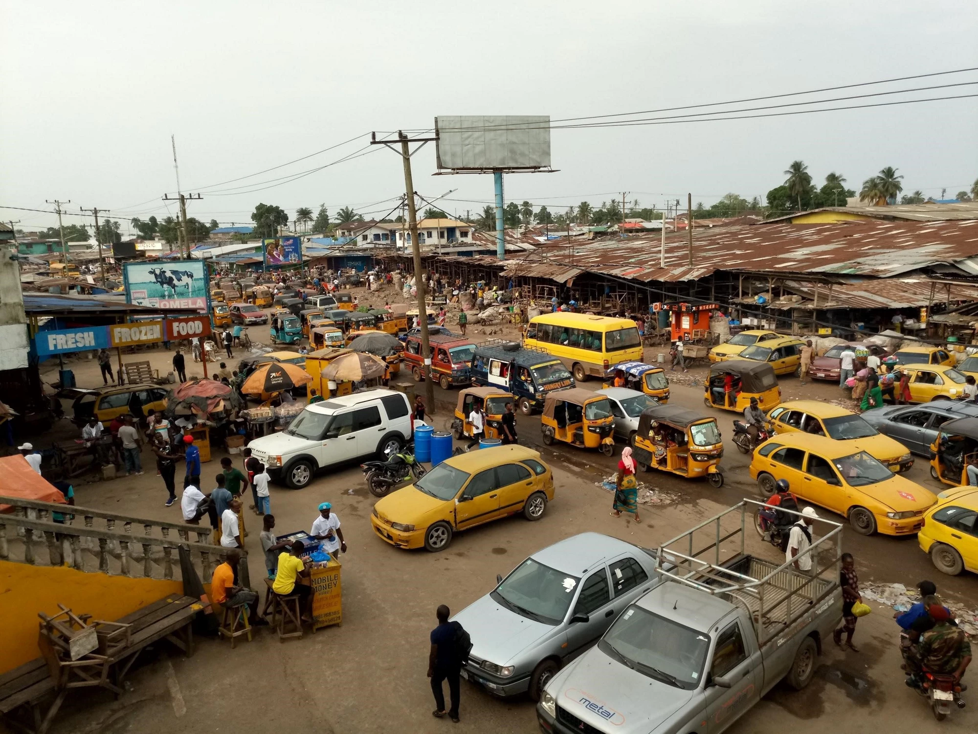 Monrovia's busy Duala Market, taxis, traffic, people