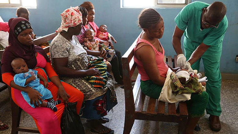 Mujer y bebé en hospital aplicando vacuna