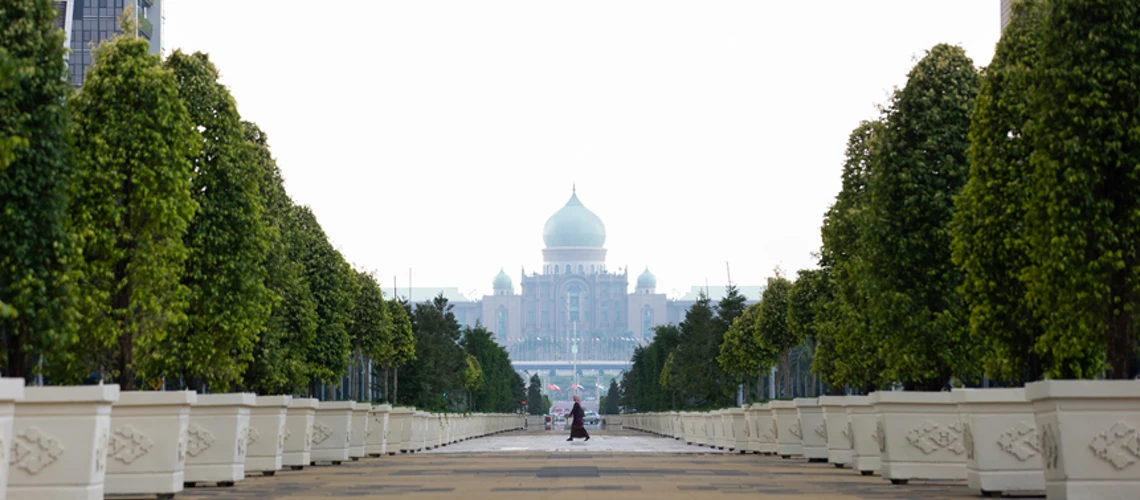 A woman walks in Putrajaya, the federal administrative center of Malaysia. As the country gears up to <a href=