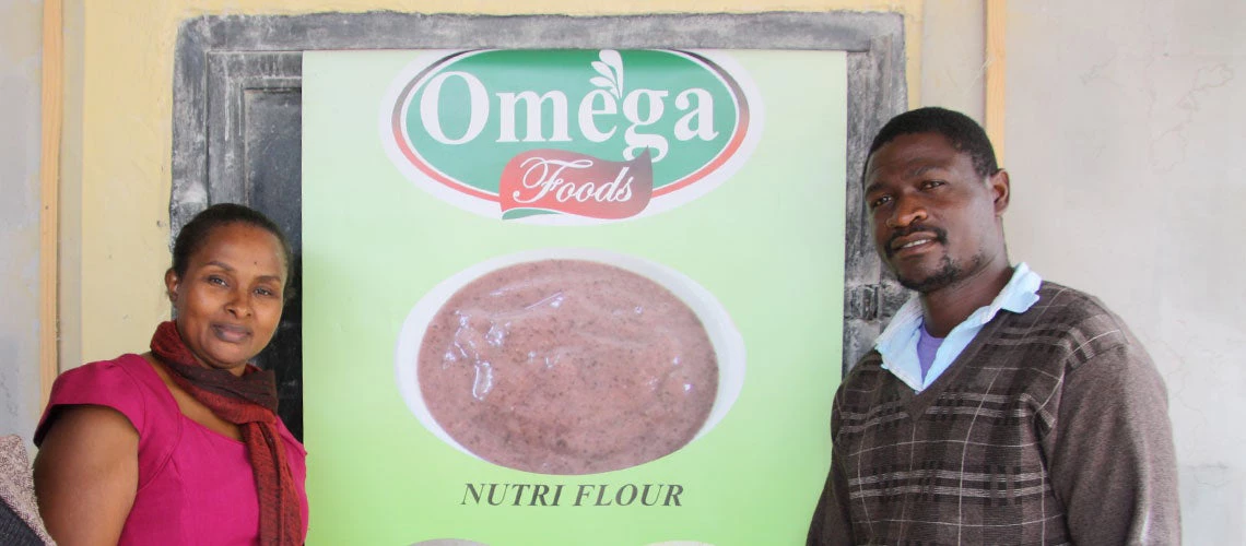 Justina Opit CEO and Co-Founder, Omega Foods, and her employees. Photo: Musopa Kalenga/World Bank