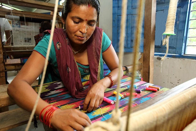A Nepali woman weaving a shawl