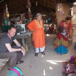 India Country Director Onno Ruhl, left, visits with a family in Gujarat.