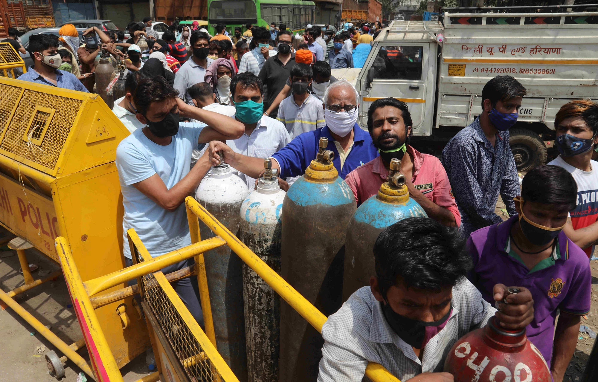 Crowd waits to get Oxygen cylinders or refills