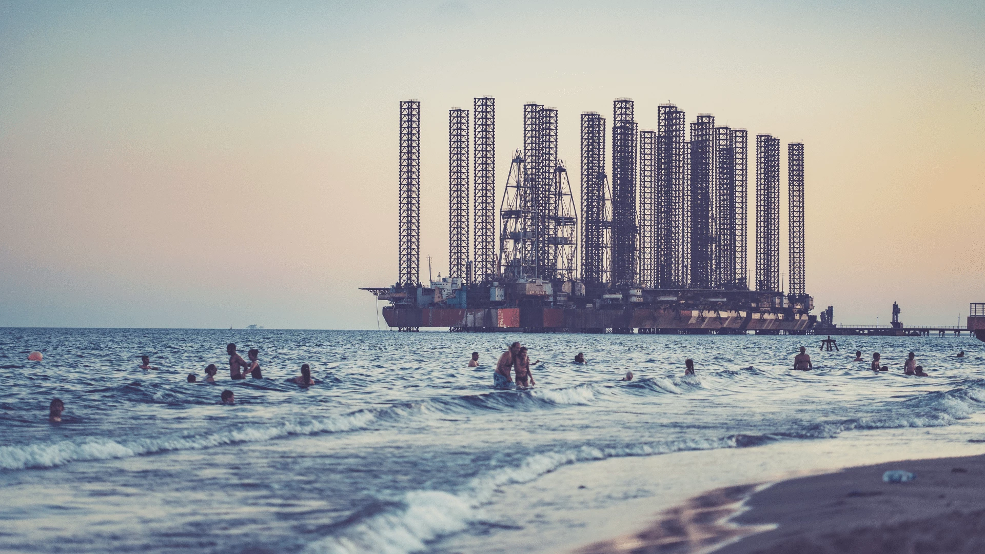 People In Front Of An Oil Rig In Azerbaijan