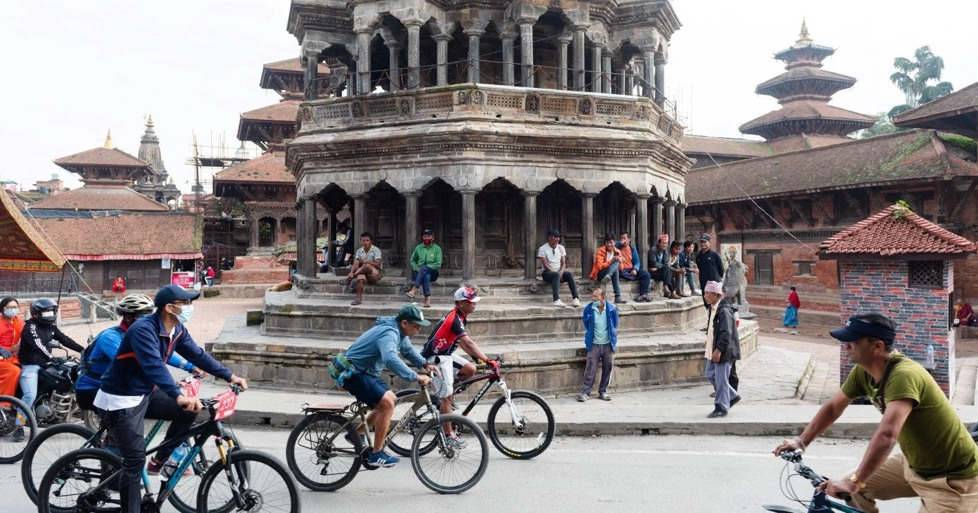 People are seen biking in Patan, Nepal